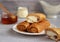 thin pancakes envelope filled with cottage cheese and raisins on a saucer with honey on a gray background