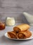 thin pancakes envelope filled with cottage cheese and raisins on a saucer with honey on a gray background