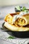 Thin pancakes with fillings. tasty stuffed pancakes crepes with cabbage closeup. Russian Fried Stuffed Pancakes Blintzes with