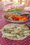 Thin sheets of lavash with herbs and cheese on the table. Close up