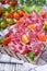 Thin slices of Italian cold cut pork Coppa and cut cherry tomatoes