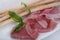 Thin slices of jamon and grissini close-up