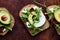 Thin toast with avocado liberally sprinkled with useful microgreens