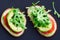 Thin toast with avocado liberally sprinkled with useful microgreens