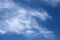 Thin white wispy clouds against blue sky