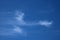Thin wispy cirrus clouds seen against blue sky