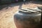 Thin wooden board on a big rusty water tank in the sandy yard