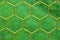 Thin yellow crossed soccer nets, soccer football in goal net with grass