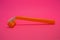 Things, personal care products, disposable, plastic, orange razor, located on pink background.