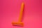 Things, personal care products, disposable, plastic, orange razor, located on pink background.