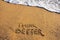 Think better sign on a sand beach