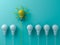 Think different concept One yellow idea light bulb standing out from the white unlit bulbs on blue green pastel color background