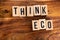 ` THINK ECO ` text made of wooden cube on  wooden background