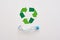 Think about ecology. Isolated recycle symbol and crumple plastic bottle