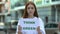Think green sign in hands of girl, teenagers campaign against deforestation