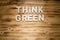 THINK GREEN words made of wooden letters on wooden board