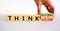 Think local or global concept. Businessman turns wooden cubes, changes words `think local` to `think global`. Beautiful white