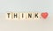 THINK message word on a wooden desk on cube blocks with