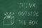 THINK OUTSIDE THE BOX on a green chalk board