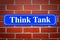 Think Tank street sign on brick wall