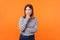 Think up plan. Portrait of pensive woman with brown hair in long sleeve striped shirt. indoor studio shot  on orange