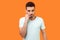 Think up plan. Portrait of puzzled thoughtful brunette man thinking over difficult question. indoor studio shot isolated on orange