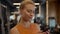 Thinking athlete woman using smartphone at gym. Sport girl texting in sport club