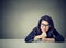 Thinking business woman sitting at desk