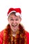 Thinking for christmas gift ideas. Funny laughing guy with a Santa hat and tinsel around the neck. Portrait