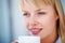 Thinking, coffee and young woman at her home relax on weekend morning for calm mindset. Smile, mug and female person