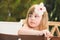 Thinking Cute Caucasian little girl with flower