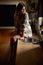 Thinking on the day ahead...a beautiful young woman sitting on the counter in a rustic kitchent.