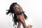 Thinking or dreaming african man with dreadlocks on white background