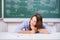 Thinking Female Teacher Chin Sitting At Desk