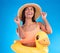 Thinking, hat and rubber duck with a woman on a blue background in studio ready for summer swimming. Happy, travel and