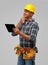 Thinking indian builder in helmet with tablet pc