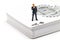 Thinking man figurine and playing card desk. Micro model of man in suit standing on trump.