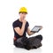 Thinking manual worker posing with a digital tablet