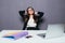 Thinking office worker day dreaming looking up smiling happy. Young business woman in suit sitting at office desk with laptop.