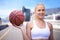 Thinking, smile and woman with a basketball, fitness and sports with happiness, New York city and training. Person