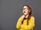 Thinking tired yawning kid girl eyeglasses on grey studio background. Closeup portrait