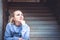 Thinking young woman sitting on stairs and look up with copy space. Concept for forecasting and way forward