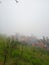 The thinning fog makes the camp visible from the hiking trail to the top of the mountain in Central Java