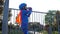 Thirst quenching, child with plastic container in arms drinks mineral water on open air