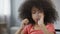 Thirsty Afro-American kid drinking still mineral water, close-up of child\'s face