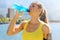 Thirsty athlete drinking power drink after long run train