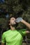 Thirsty athlete drinking water after workout