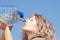 Thirsty blond woman on desert