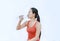 Thirsty fitness girl drinking bottle of water