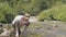 Thirsty man drinking spring water from hand while hiking mountain